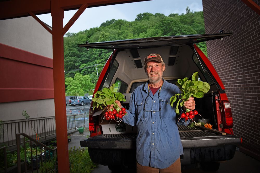 Grower at farmers market_Radishes_Ag Crops_Western NC (1) Healing garden